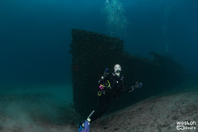 Ancient Mariner - A diver poses port side of the wreck