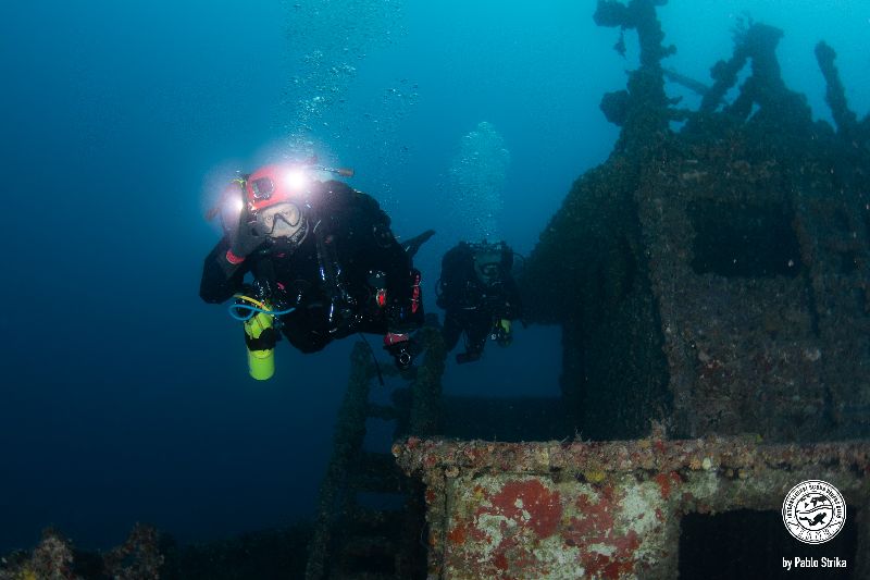 Miss Lourdes - A diver hovers near the bow superstructure