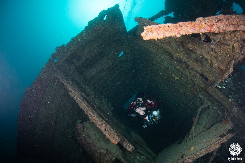 Rebel - A diver comes out from the inside of the wreck