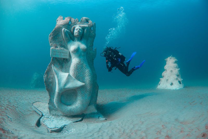 Mermaids - A diver hovers near one of the mermaid sculptures