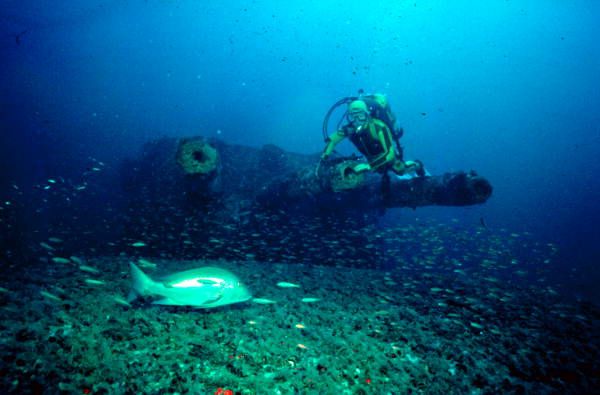 Wilkes-Barre - A diver poses in front of one of the 6-inch guns