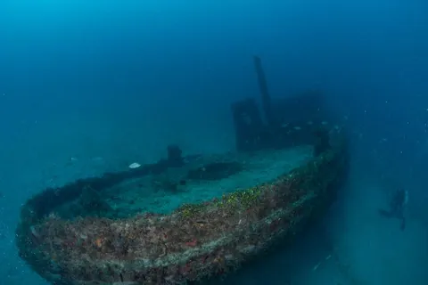 Three Tugs - The tugboat sits slightly tilted to its port side